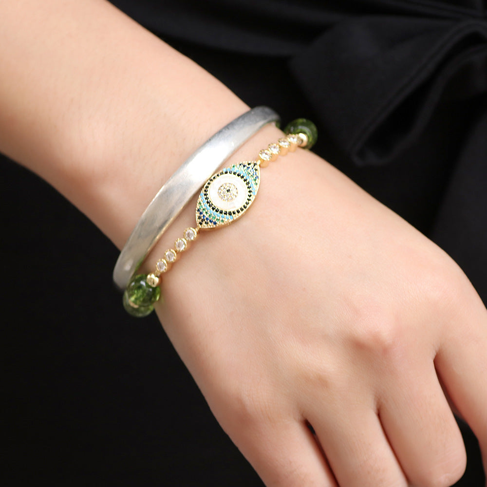 Pulsera de Ojo Turco con Piedras de Peridoto – Protección y Elegancia Dorada.